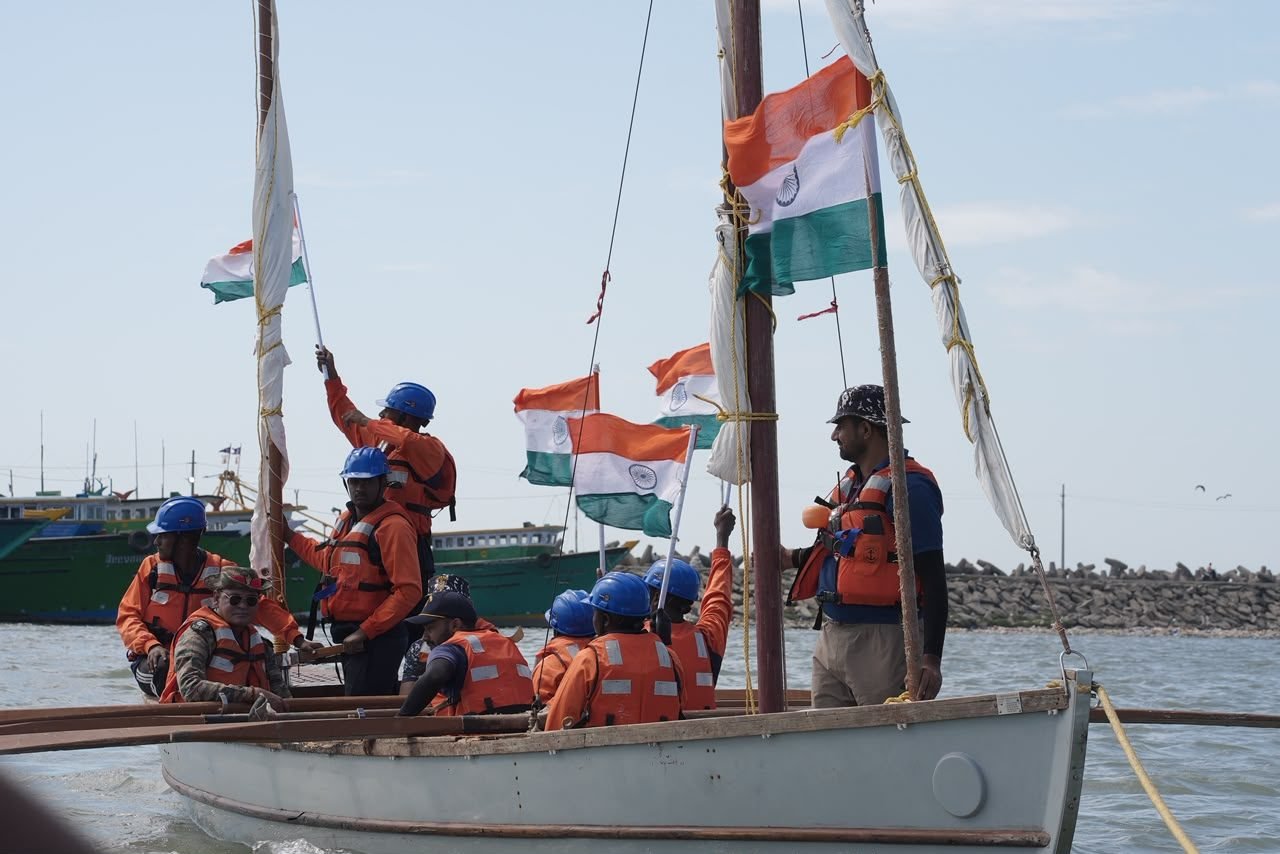 Cadets raising the national tricolour flags aboard a sailboat