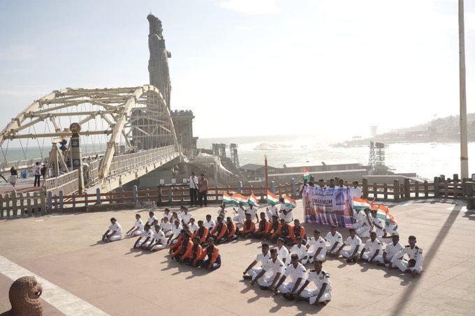 The contingent seated in formation on the memorial bridge at Kanniyakumari
