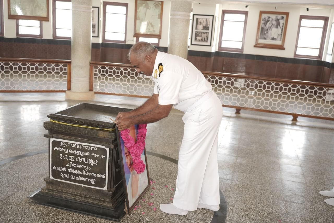Naval officers standing to attention beside unit standards at a Tuticorin parade