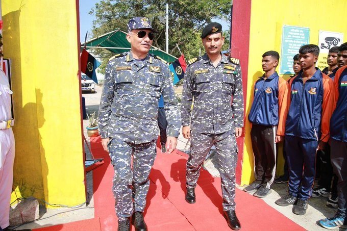 Two senior officers being received on the red carpet at a parade venue