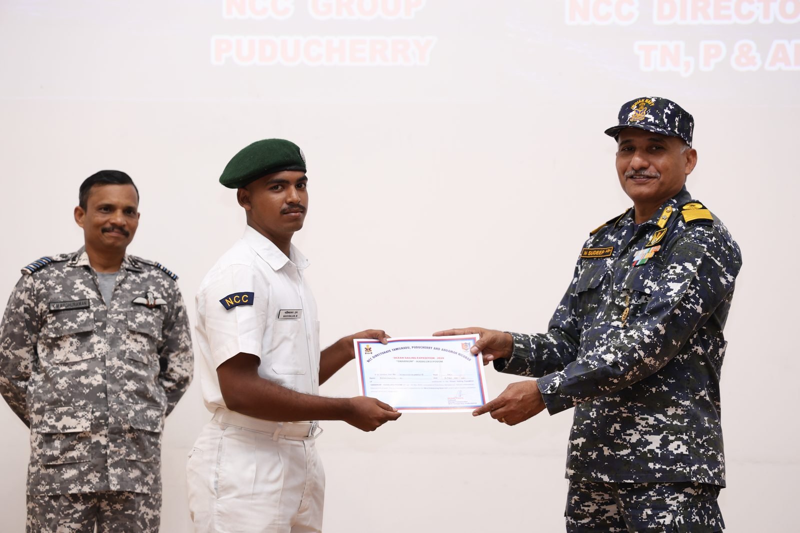 Cadet receiving a certificate from a naval officer at the closing ceremony