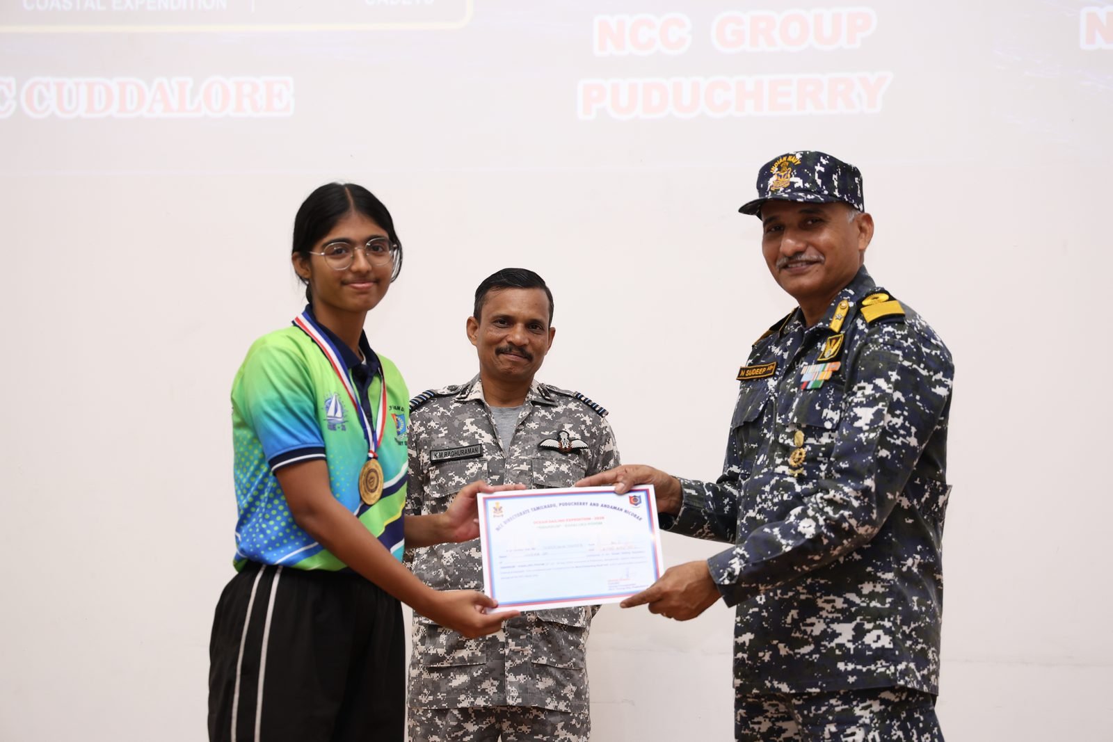 Woman cadet presented a certificate and medal at the closing ceremony