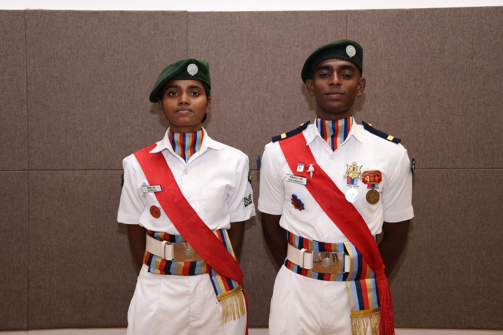Two NCC cadets in ceremonial uniform with sashes and medals