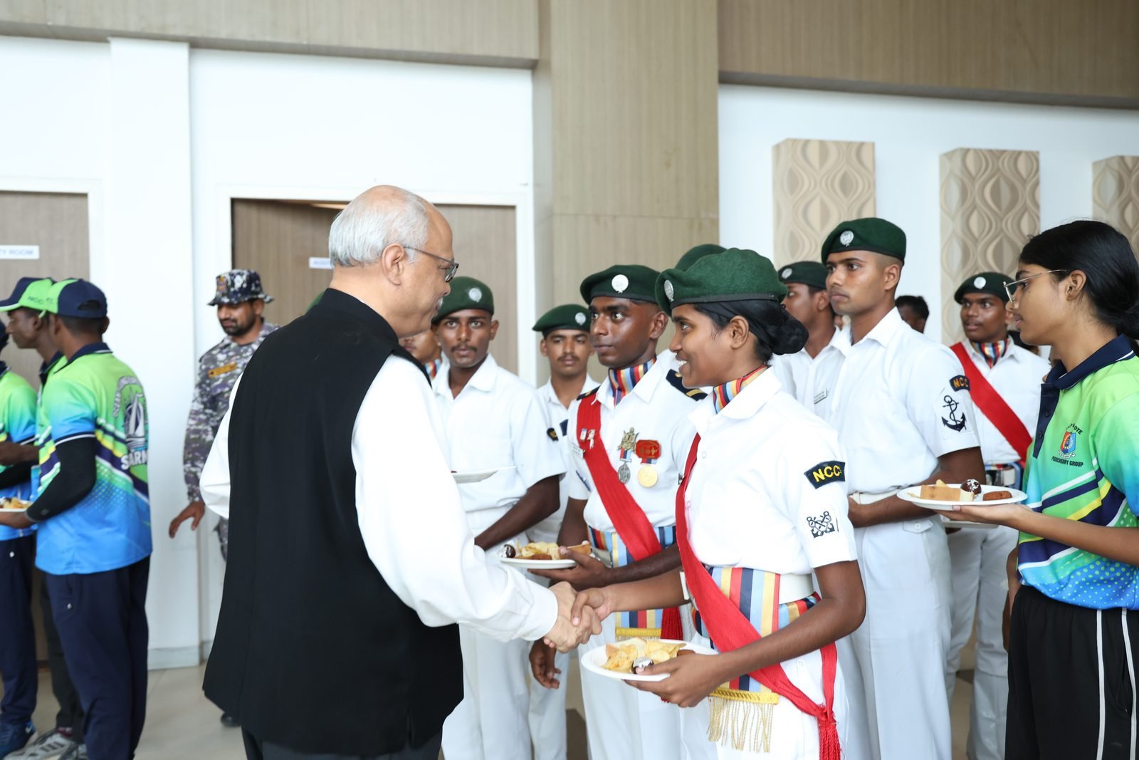 Chief guest greeting NCC cadets at the reception