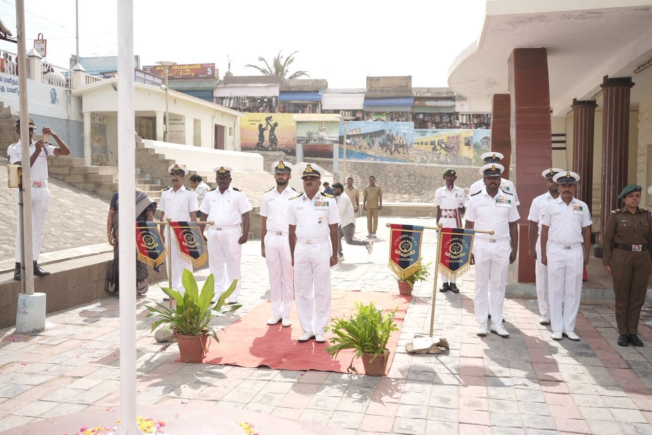 Naval officers standing in formation with Tuticorin unit standards on the Kanyakumari seafront