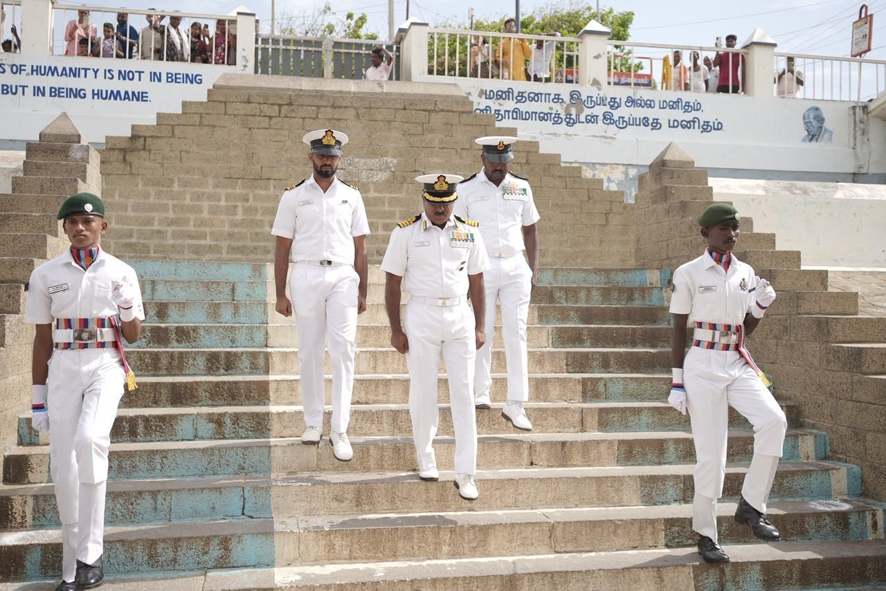 Officers descending the Gandhi Memorial steps beside the Gandhi humanity inscription
