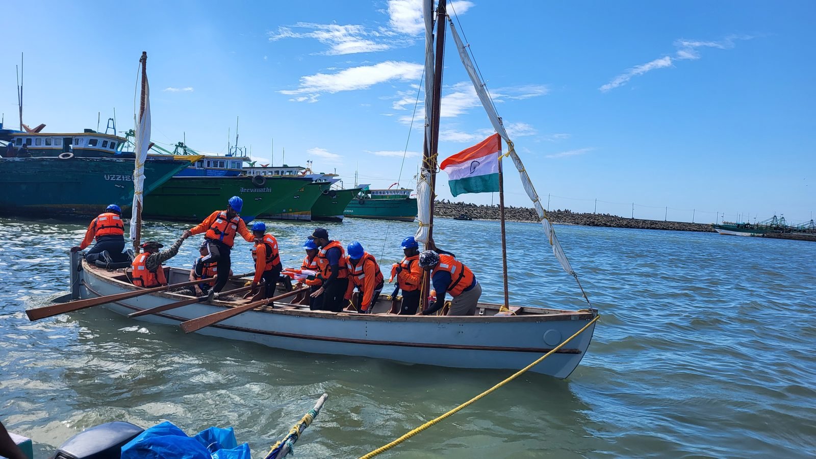 Indian tricolour flying from the mast with fishing boats in the background
