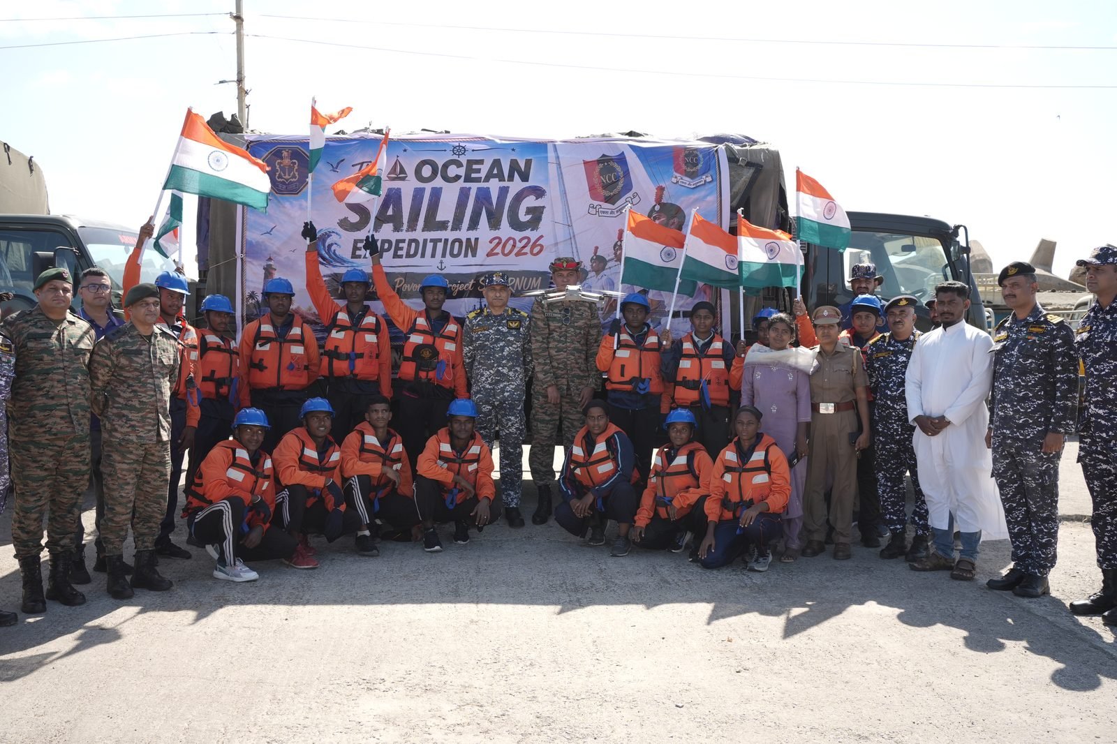 Group photo with Ocean Sailing Expedition 2026 banner, cadets waving Indian tricolours