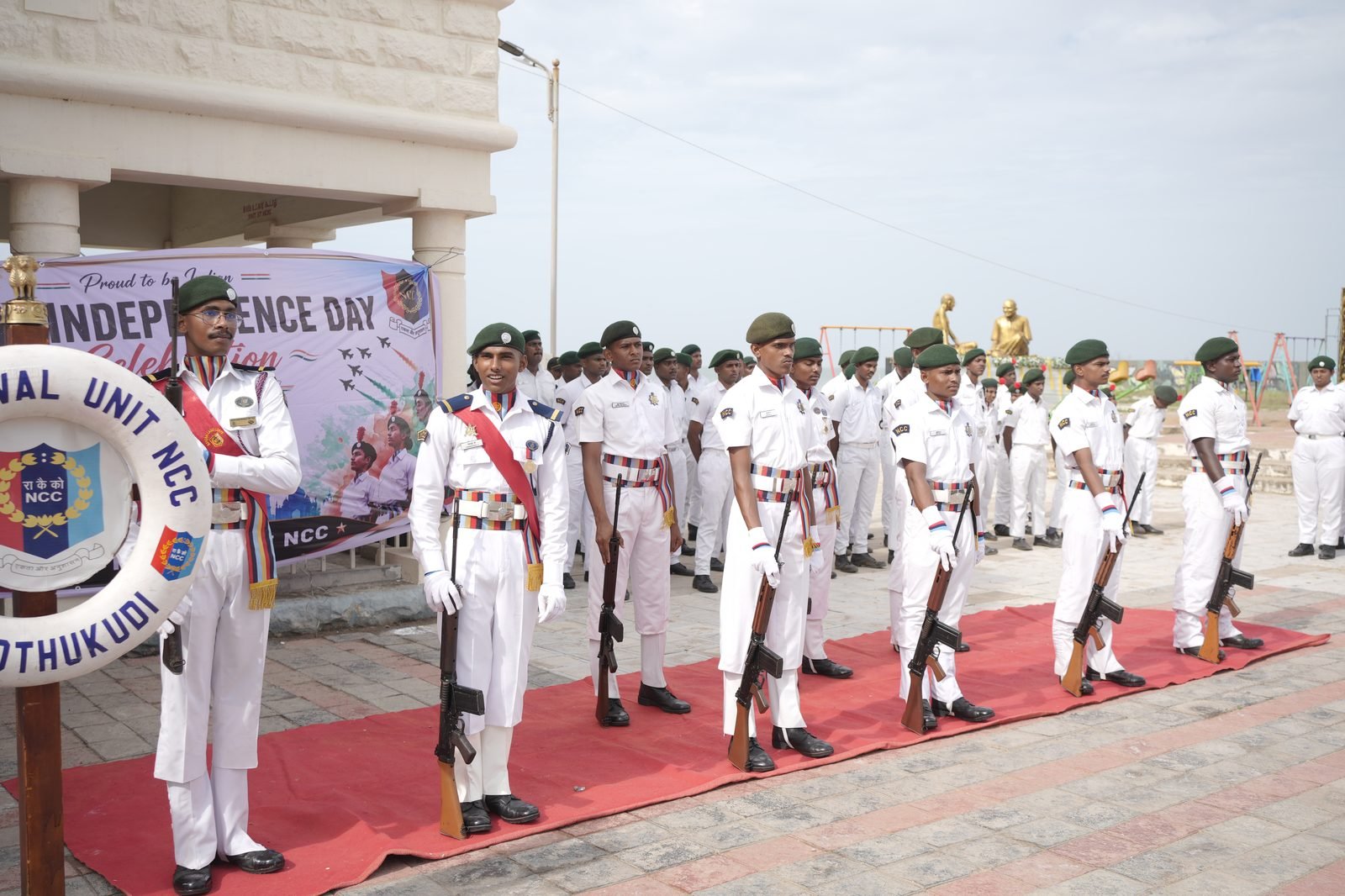 NCC cadet hoisting the tricolour at flag ceremony, officers and cadets at attention