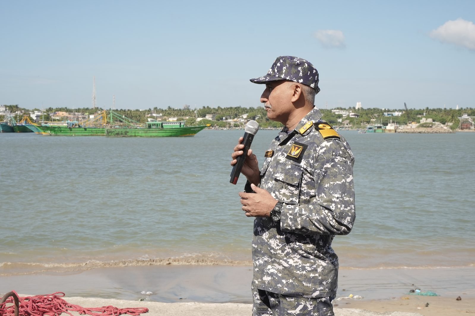 Instructor demonstrating sail trim to cadets