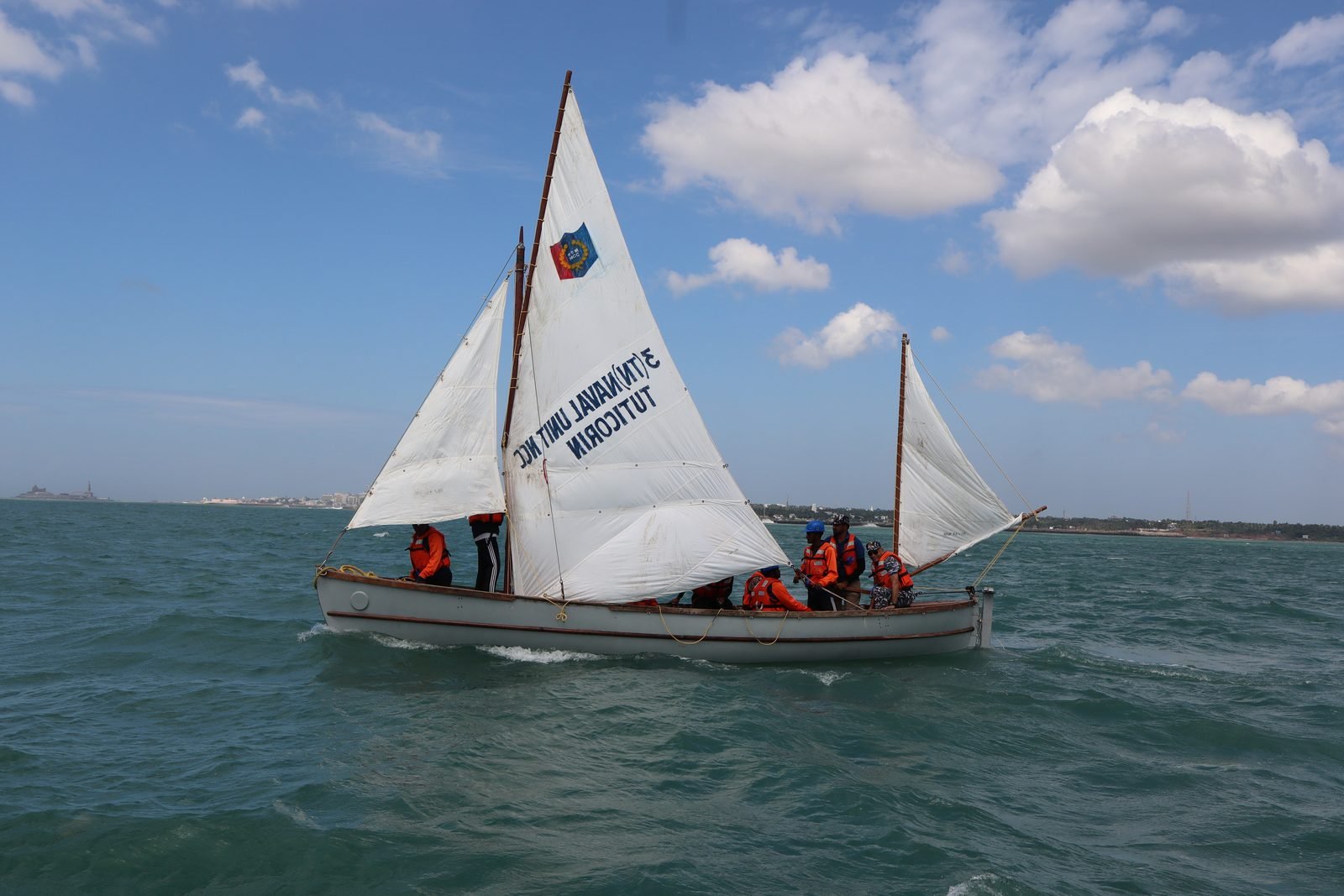 Cadets assembling kit on the beach for the day's sail