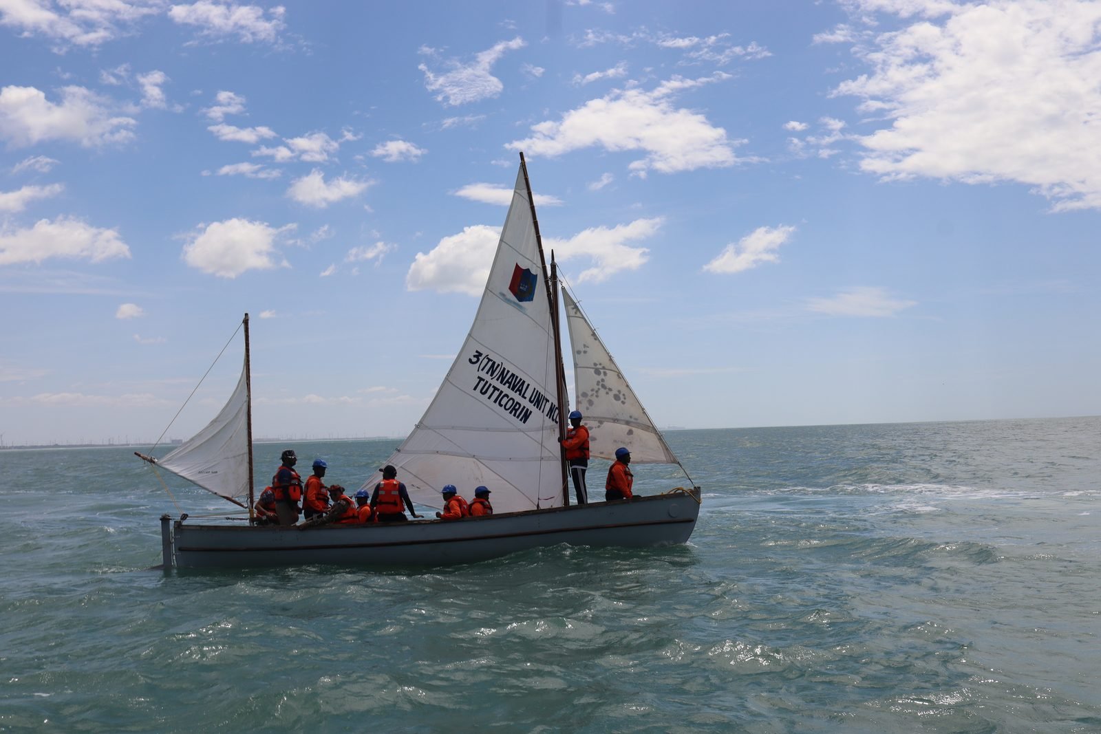 Whaler on a close reach along the coastline