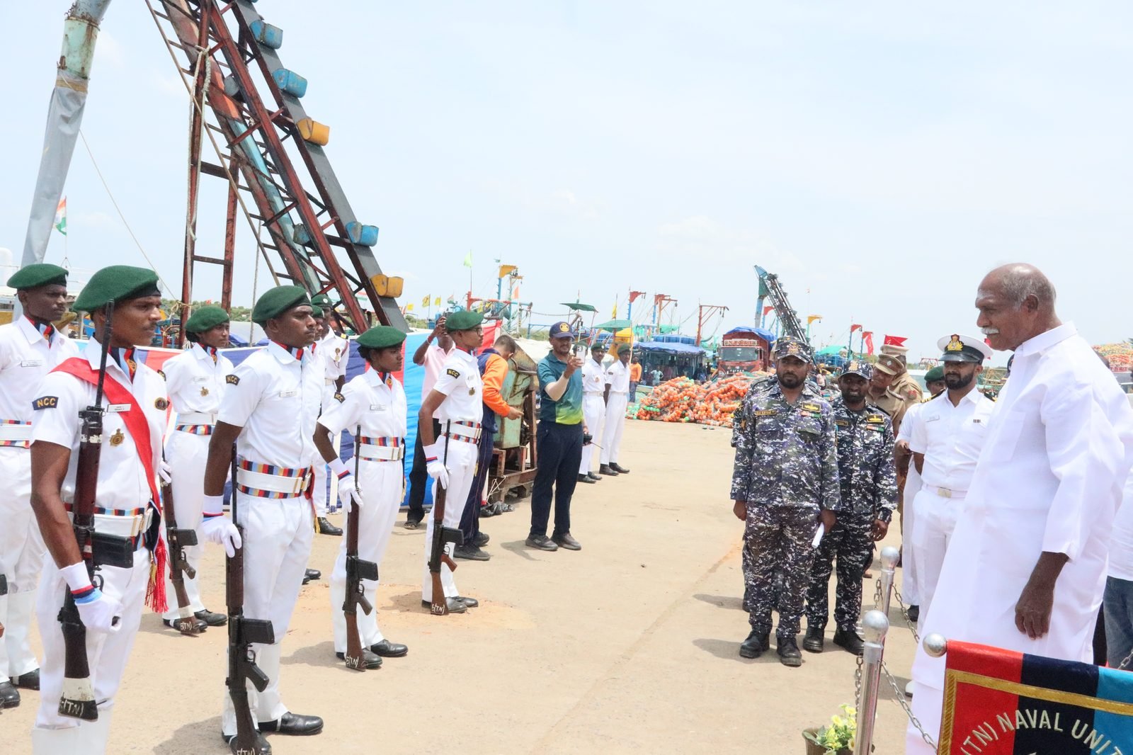 NCC cadets in ceremonial whites with rifles presenting guard of honour