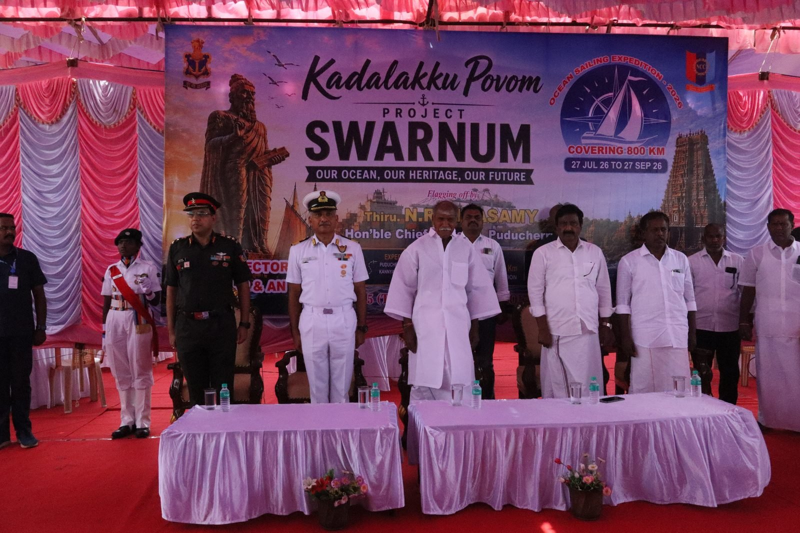 Ceremony under the shamiana with officials and the SWARNUM backdrop