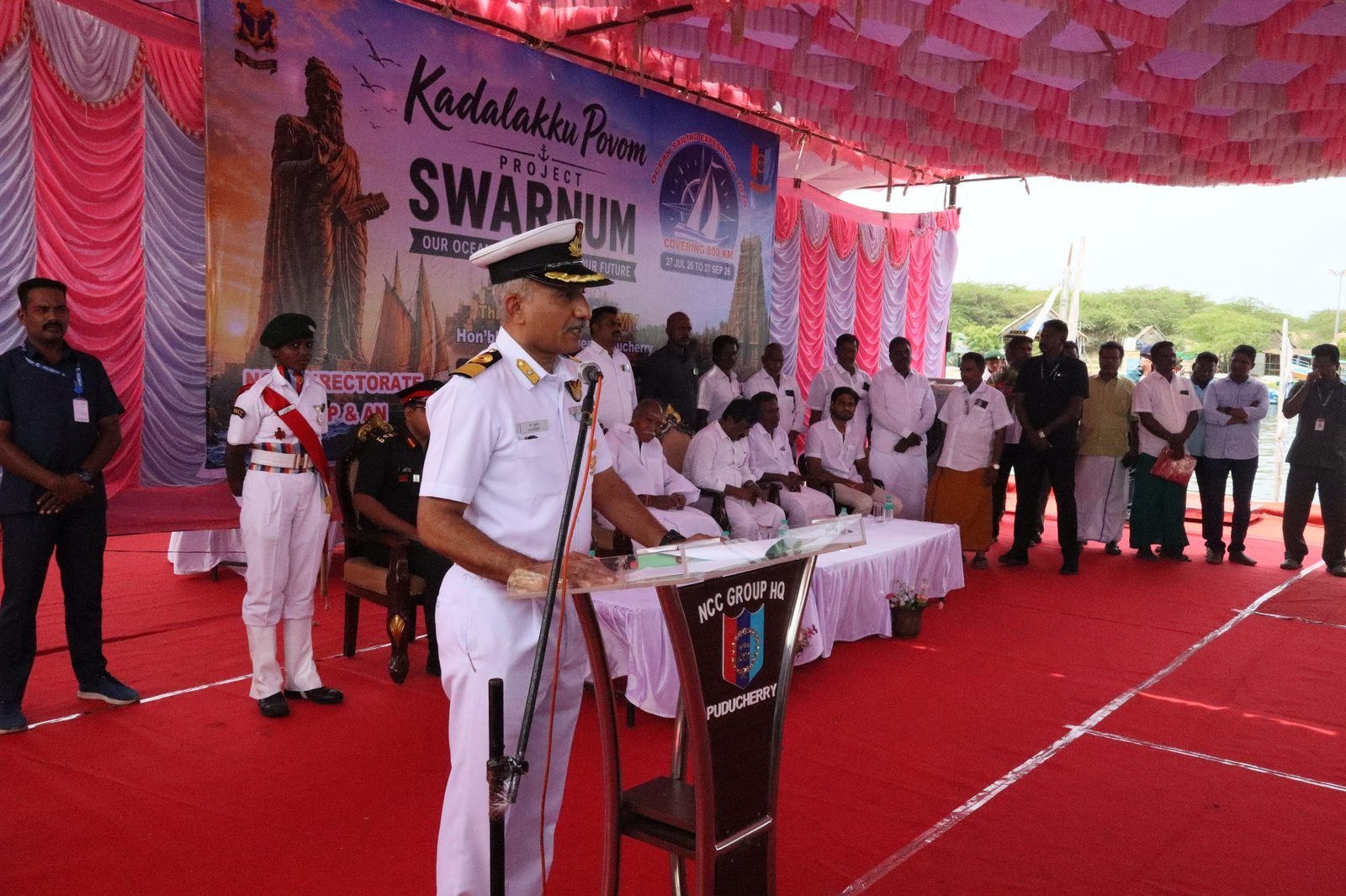 DDG speaking at the podium with SWARNUM banner behind