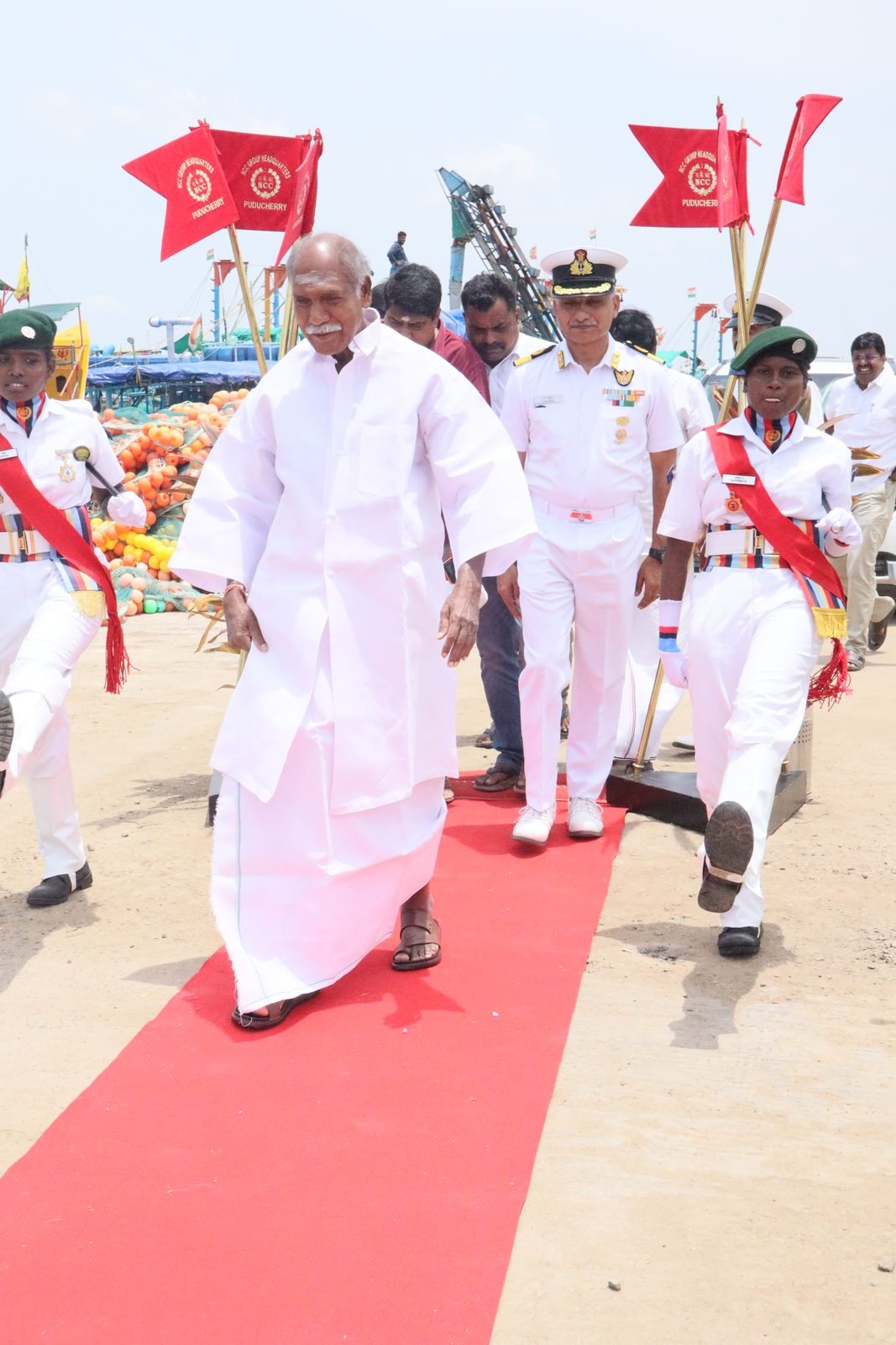 Officers in white ceremonial uniform at the pier