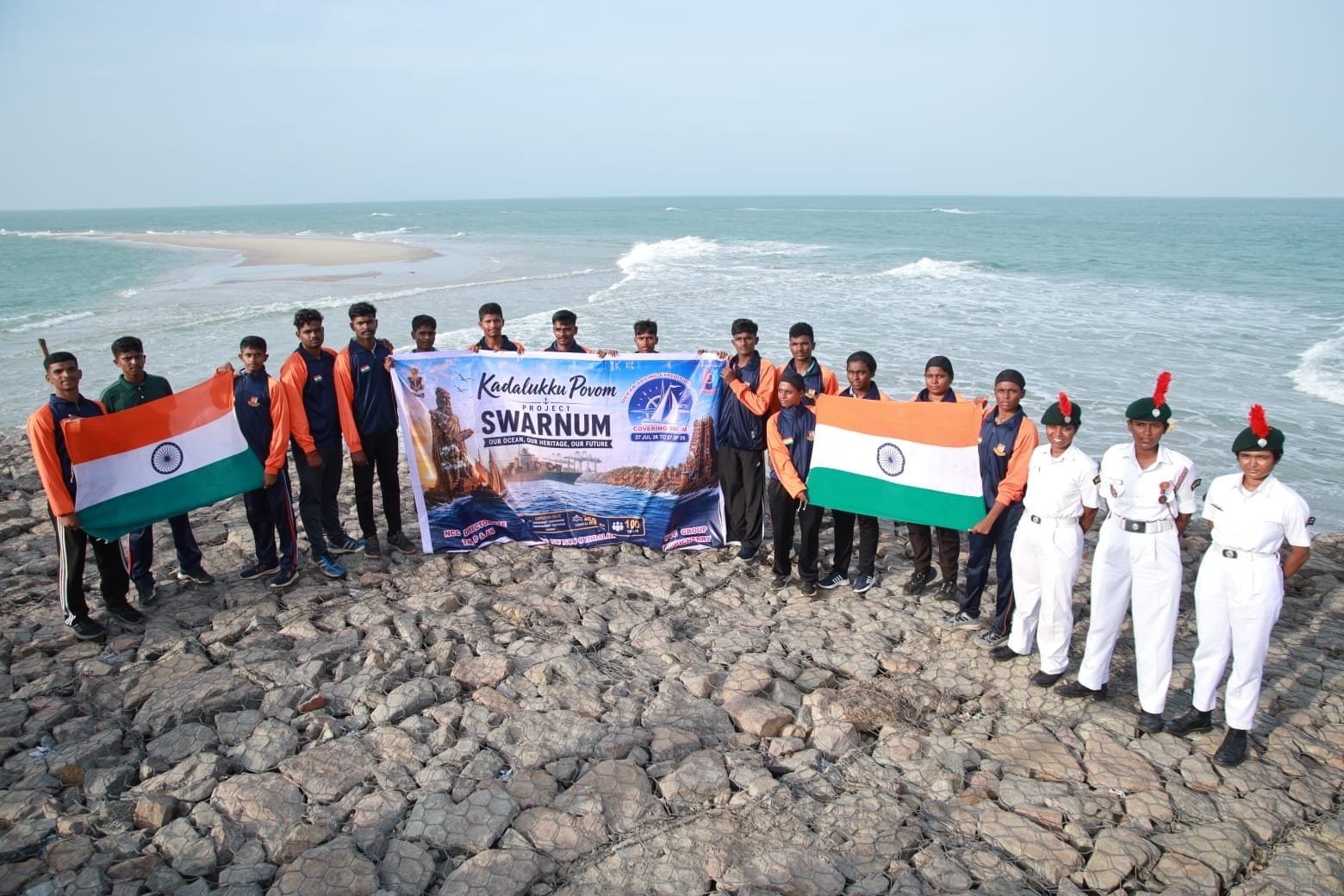 NCC cadets holding the Kadalukku Povom Project SWARNUM banner at Rameshwaram