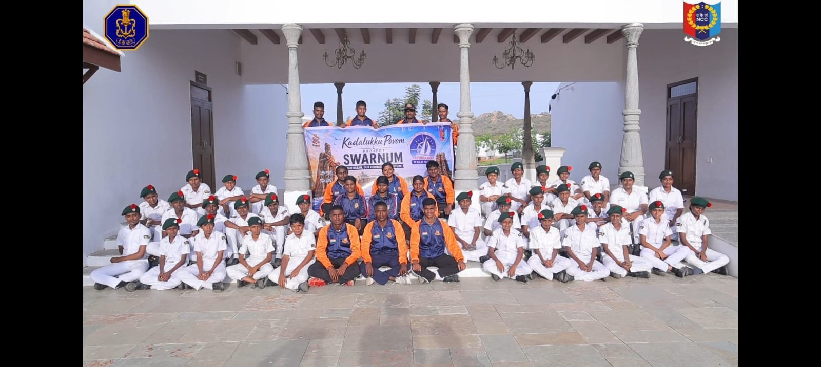 Large group photograph with cadets and officers in front of the Kadalukku Povom Project SWARNUM banner